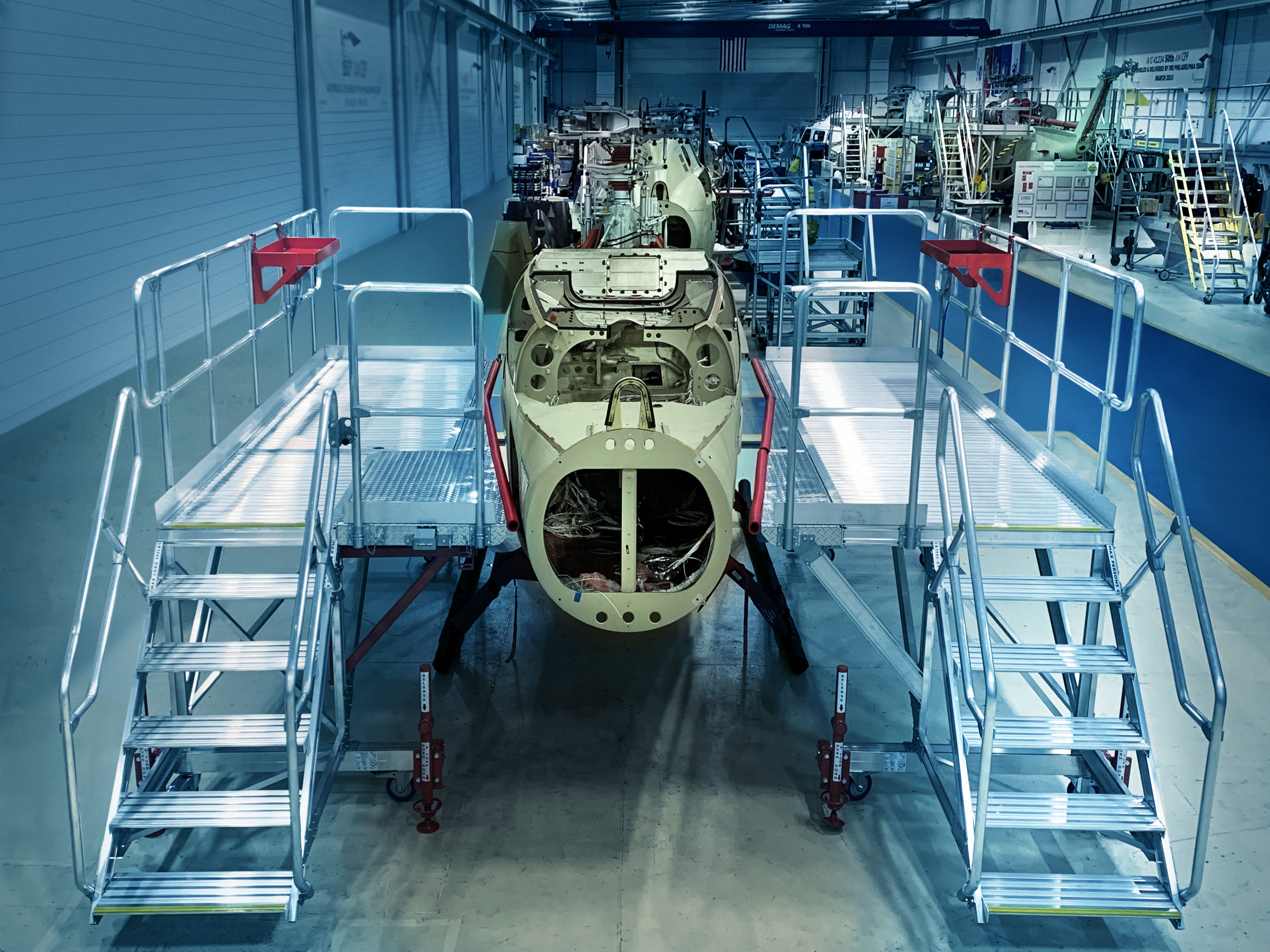 Semmco access platforms positioned around a helicopter airframe on a manufacturing line